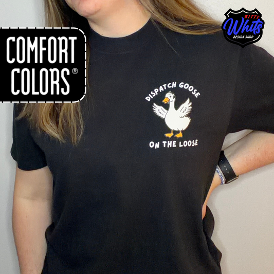 Person wearing a black Comfort Colors t-shirt with a 'Dispatch Goose on the Loose" graphic.