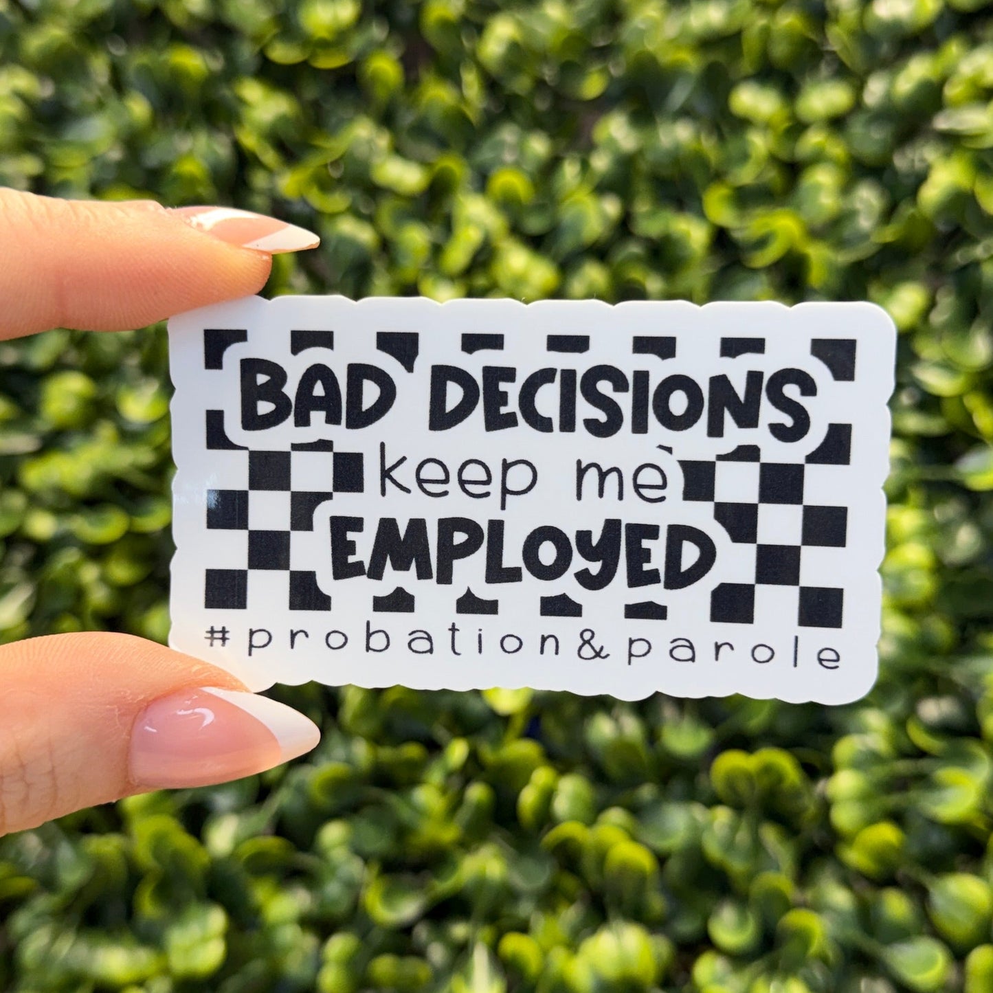 black and white sticker for probation officers that says 'bad decisions keep me employed' on a green background