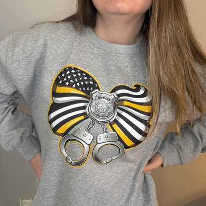 Gray sweatshirt with a graphic design featuring an American flag, police badge, and handcuffs.
