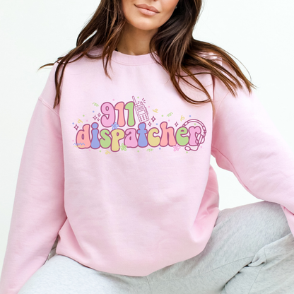Person wearing a pink sweatshirt with '911 dispatcher' text and graphics.