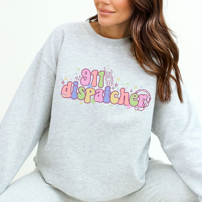 Person wearing a gray sweatshirt with '911 dispatcher' text in colorful letters.