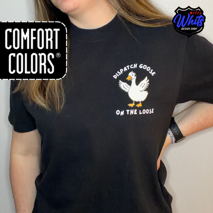 Person wearing a black Comfort Colors t-shirt with a 'Dispatch Goose on the Loose" graphic.