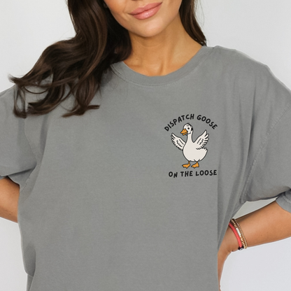 Person wearing a grey Comfort Colors t-shirt with a 'Dispatch Goose on the Loose" graphic.