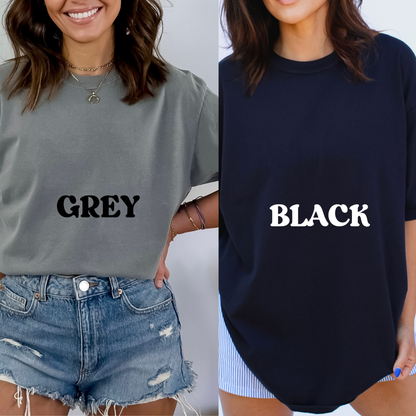 Two people wearing t-shirts with 'GREY' and 'BLACK' text.